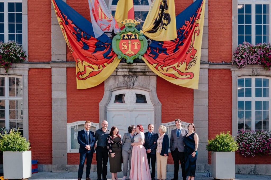 familiefoto voor het stadhuis van Sint-Truiden met vlaggen